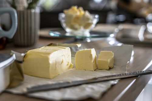 An image of butter being sliced for cooking