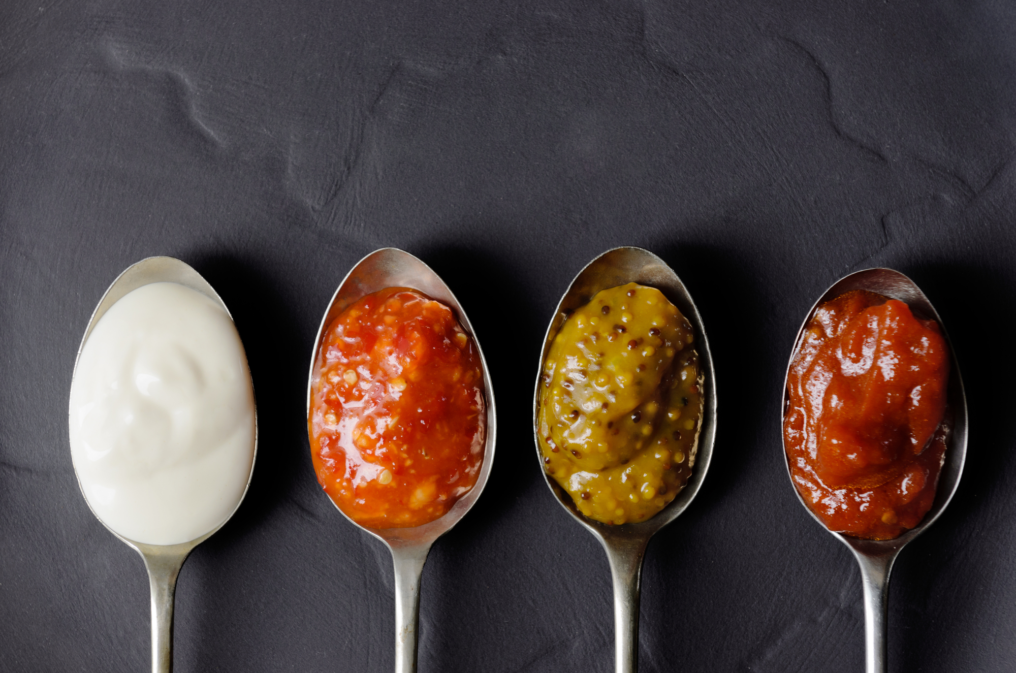 keto condiments spoonfuls of sauces in a row